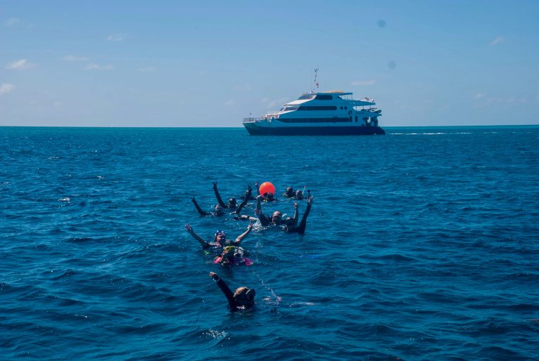 Drift Dives in the Bahamas - Dive liveaboard Aqua Cat picking up divers after doing the drift dive Washing Machine in the Exumas.